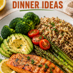 Healthy Fish Dinner Ideas featuring grilled lemon garlic salmon with quinoa, roasted asparagus, broccoli, avocado, and fresh vegetables on a white plate.